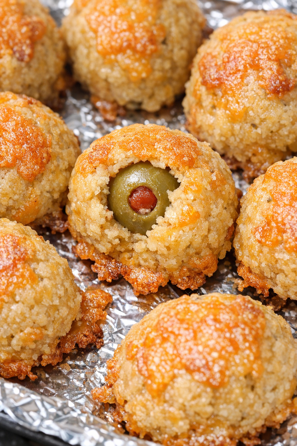 Southern 3-ingredient cheese olive balls on a foil-lined baking tray