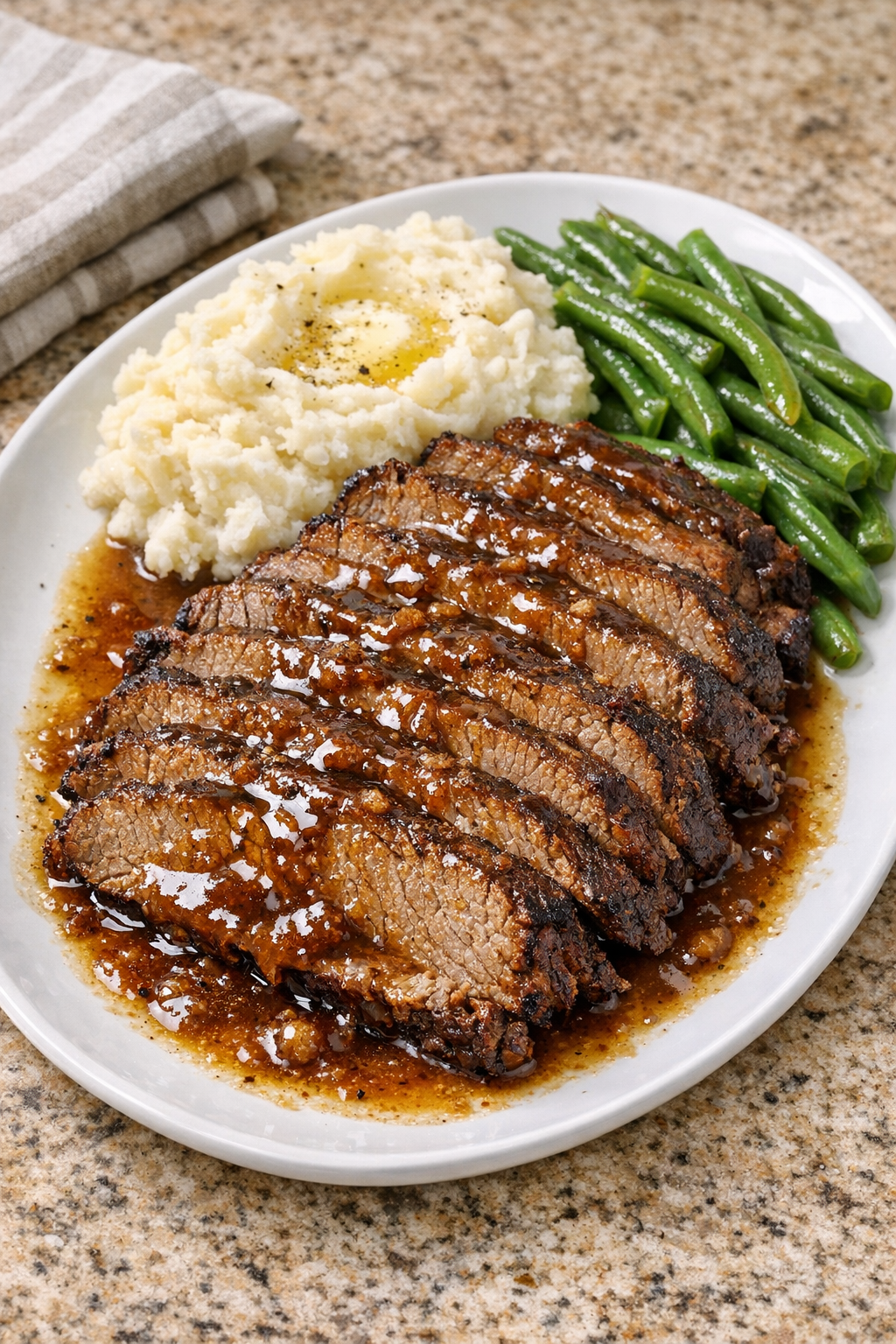 Finished brown sugar brisket plated with rich sauce