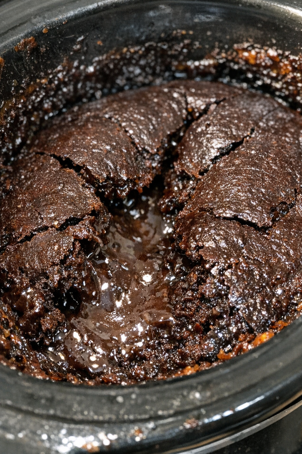 Chocolate dessert with a cracked dark crust in a slow cooker