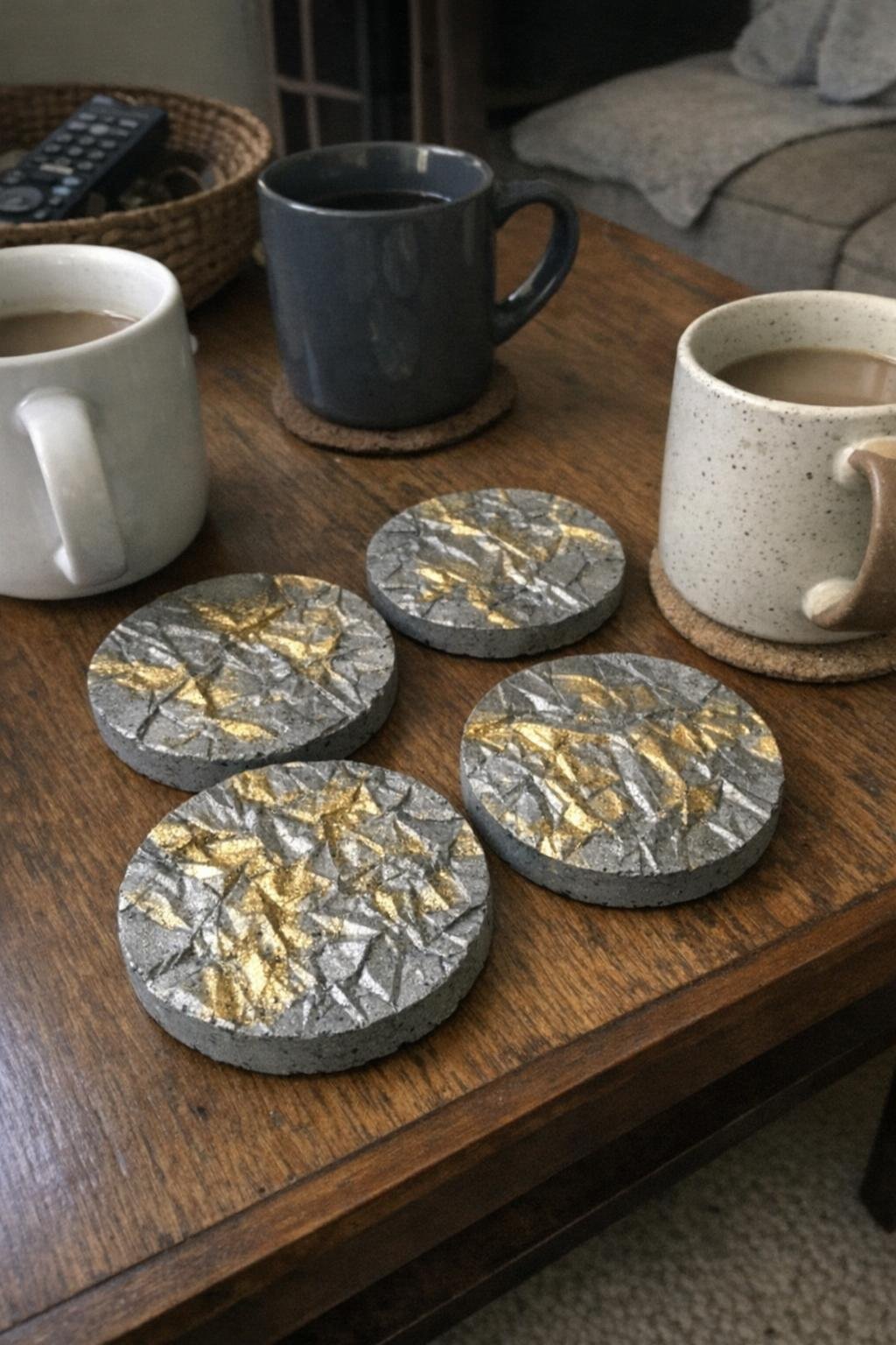 Concrete coasters with crinkled texture and gold highlights