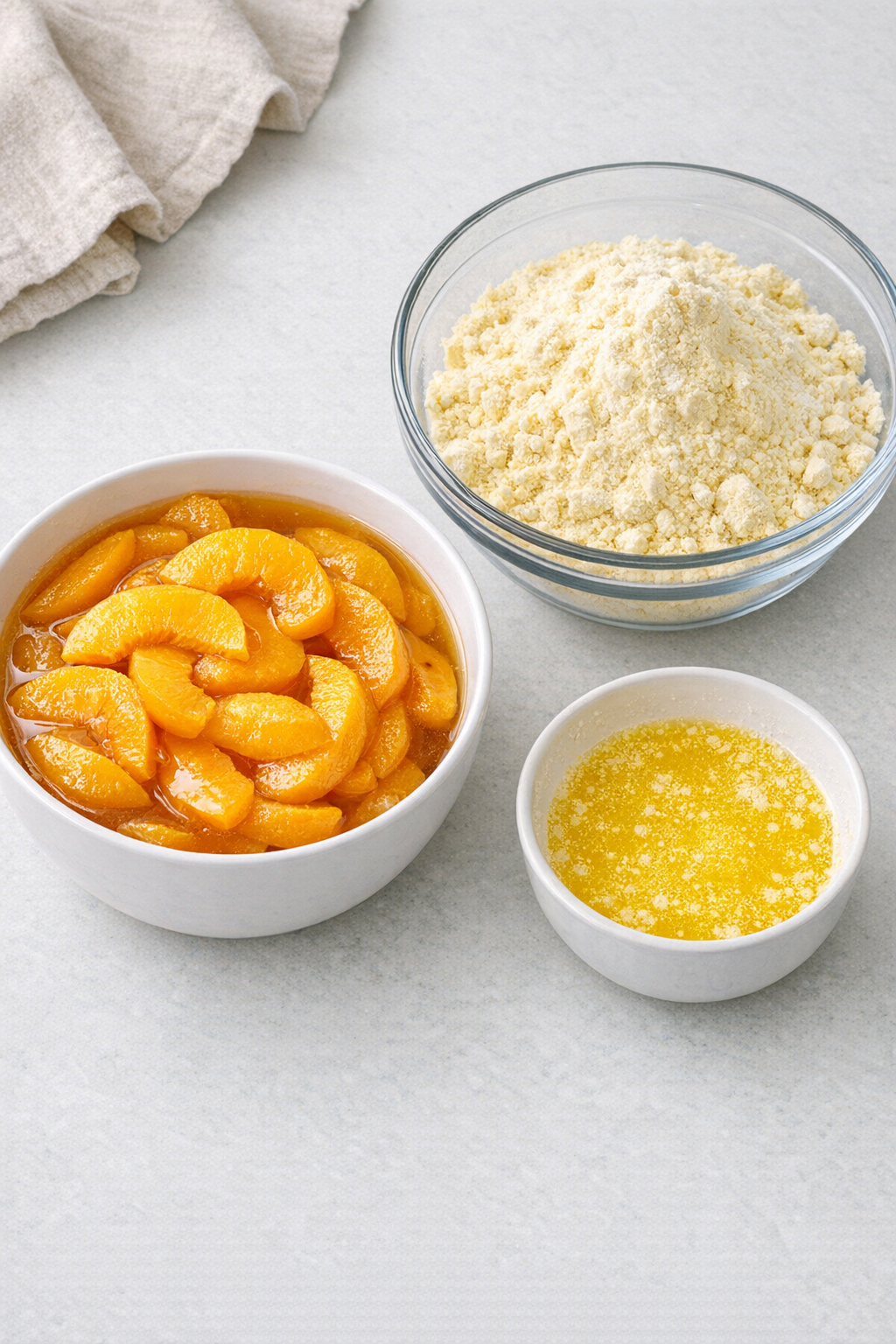 Peaches, cake mix, and melted butter ingredients