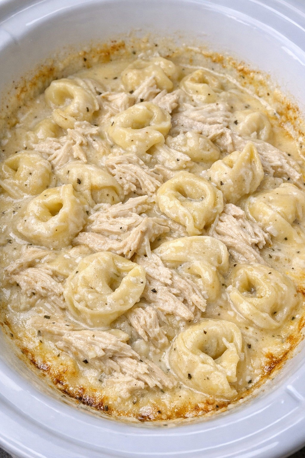 Creamy tortellini chicken in a white slow cooker