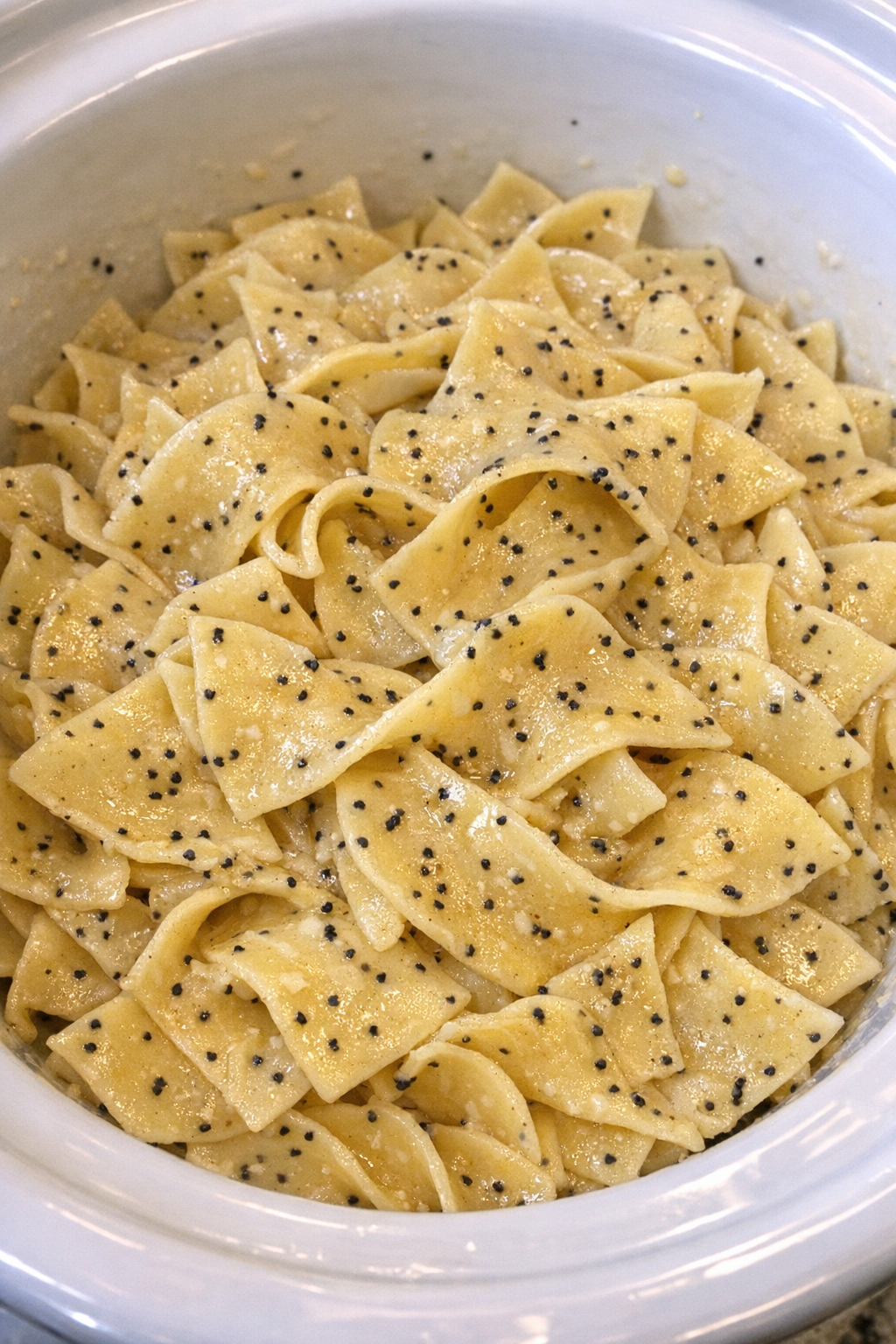 Slow cooker Amish poppy seed noodles in a white slow cooker