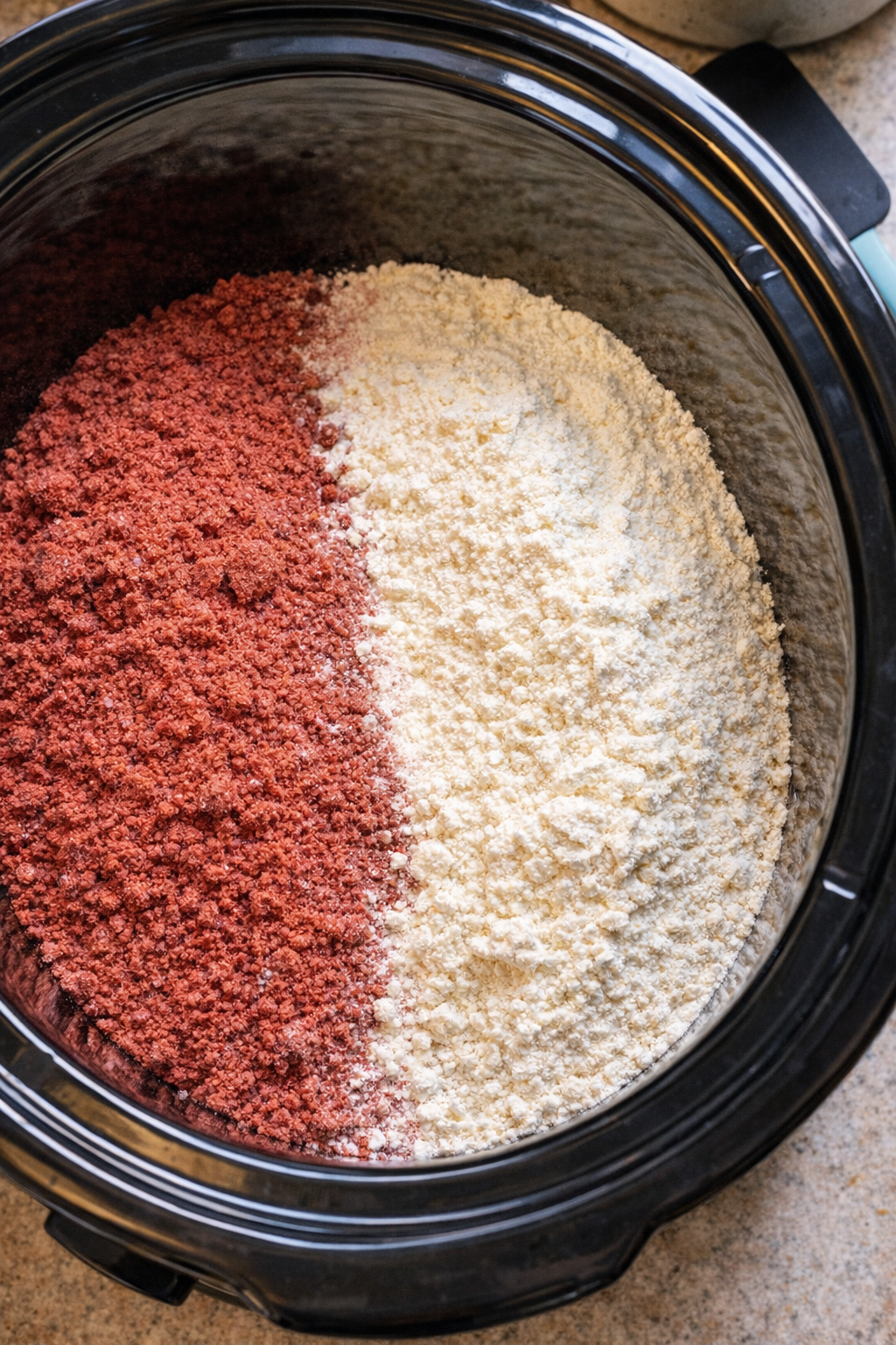 Red velvet cake mix and pudding mix in a slow cooker insert