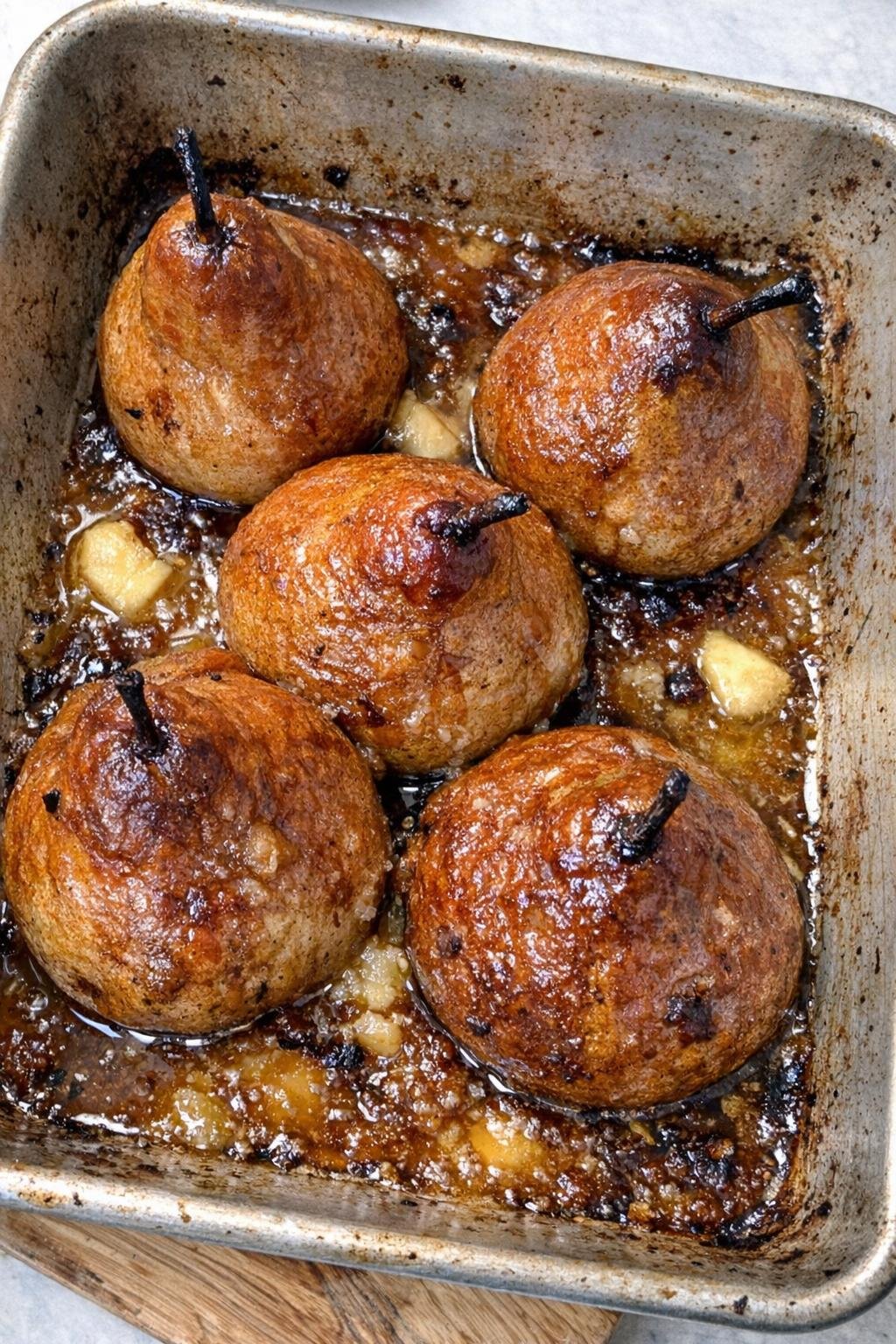 Finished baked pears in a roasting pan