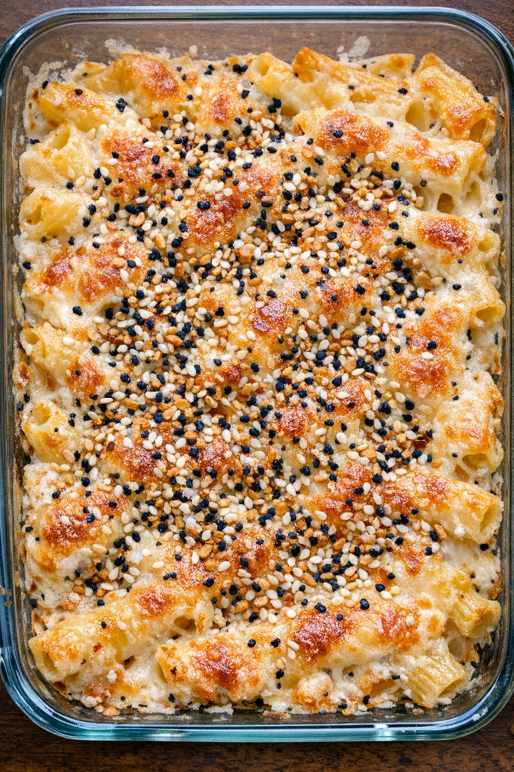 Creamy baked ziti with everything bagel seasoning in a glass baking dish