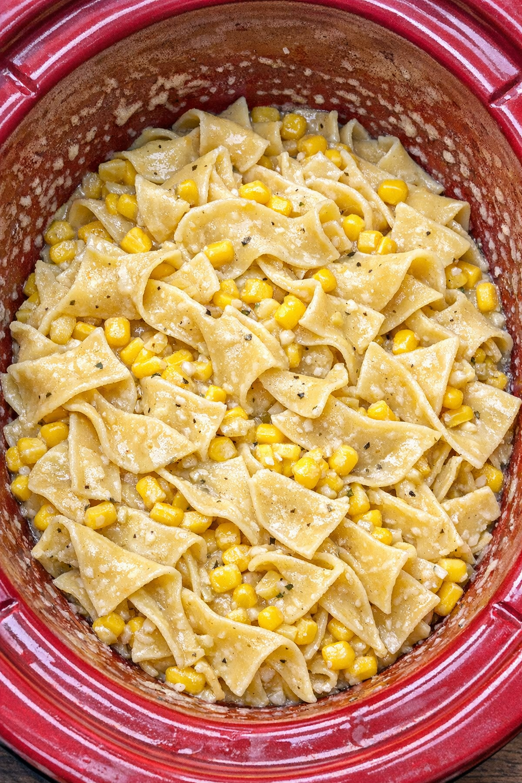 Slow cooker Amish sweet corn noodles in a red slow cooker