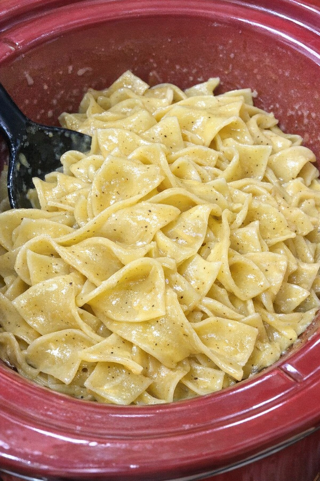 Slow cooker Amish mustard noodles in a red slow cooker