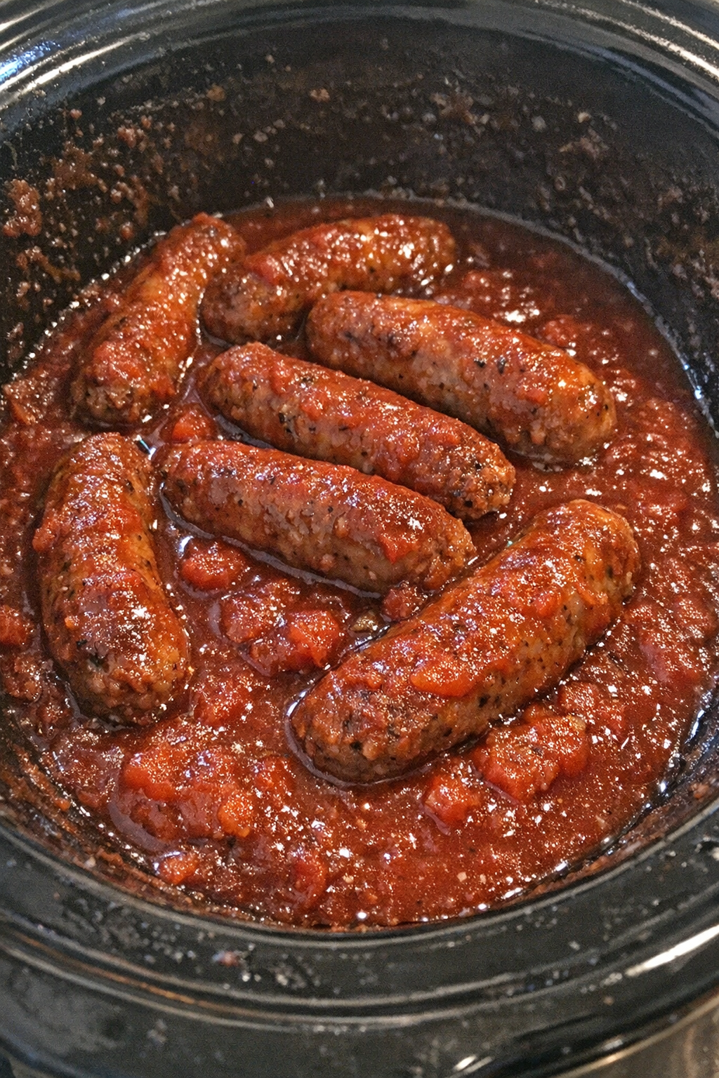 Slow cooker Italian sausage in glossy crimson sauce