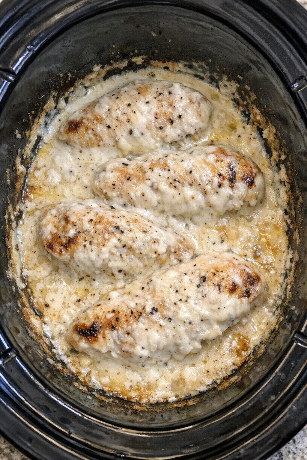 Slow cooker Amish sour cream chicken in a black slow cooker
