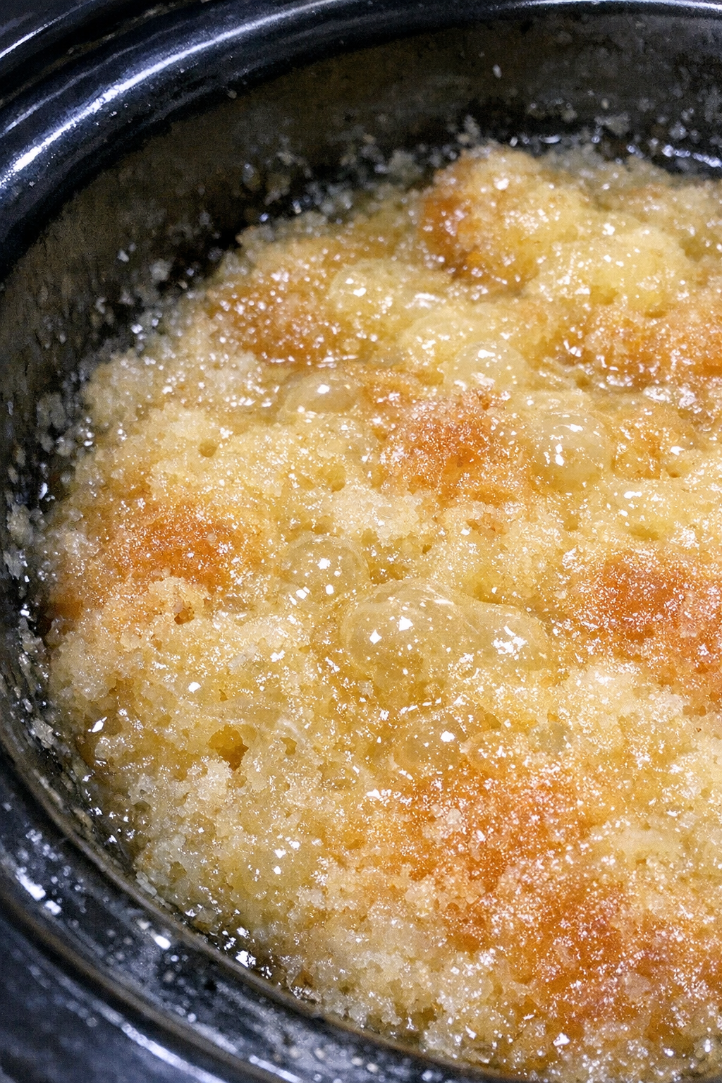 Bubbling slow cooker dessert with pale-yellow glaze