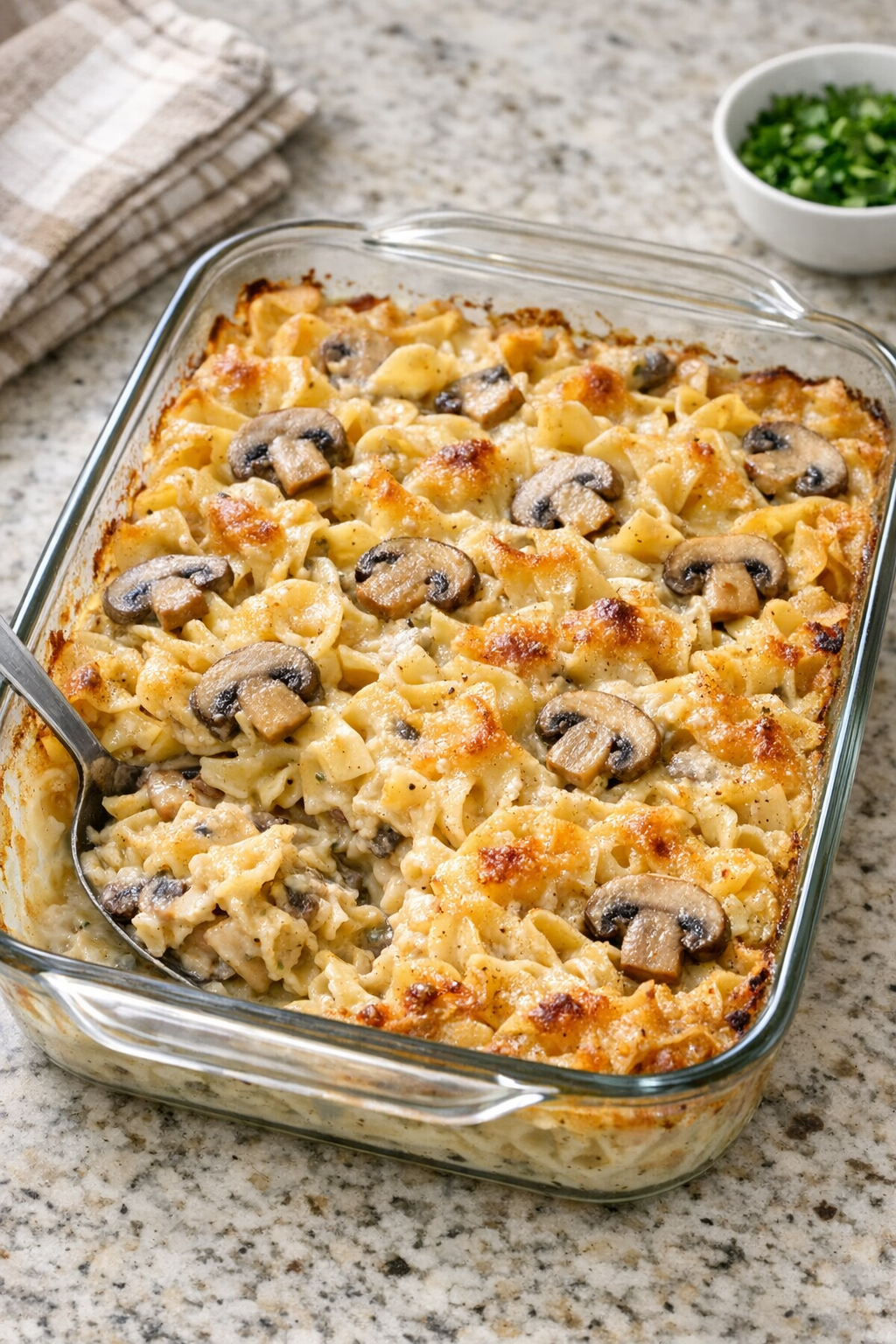 Finished baked mushroom noodle casserole in a glass baking dish