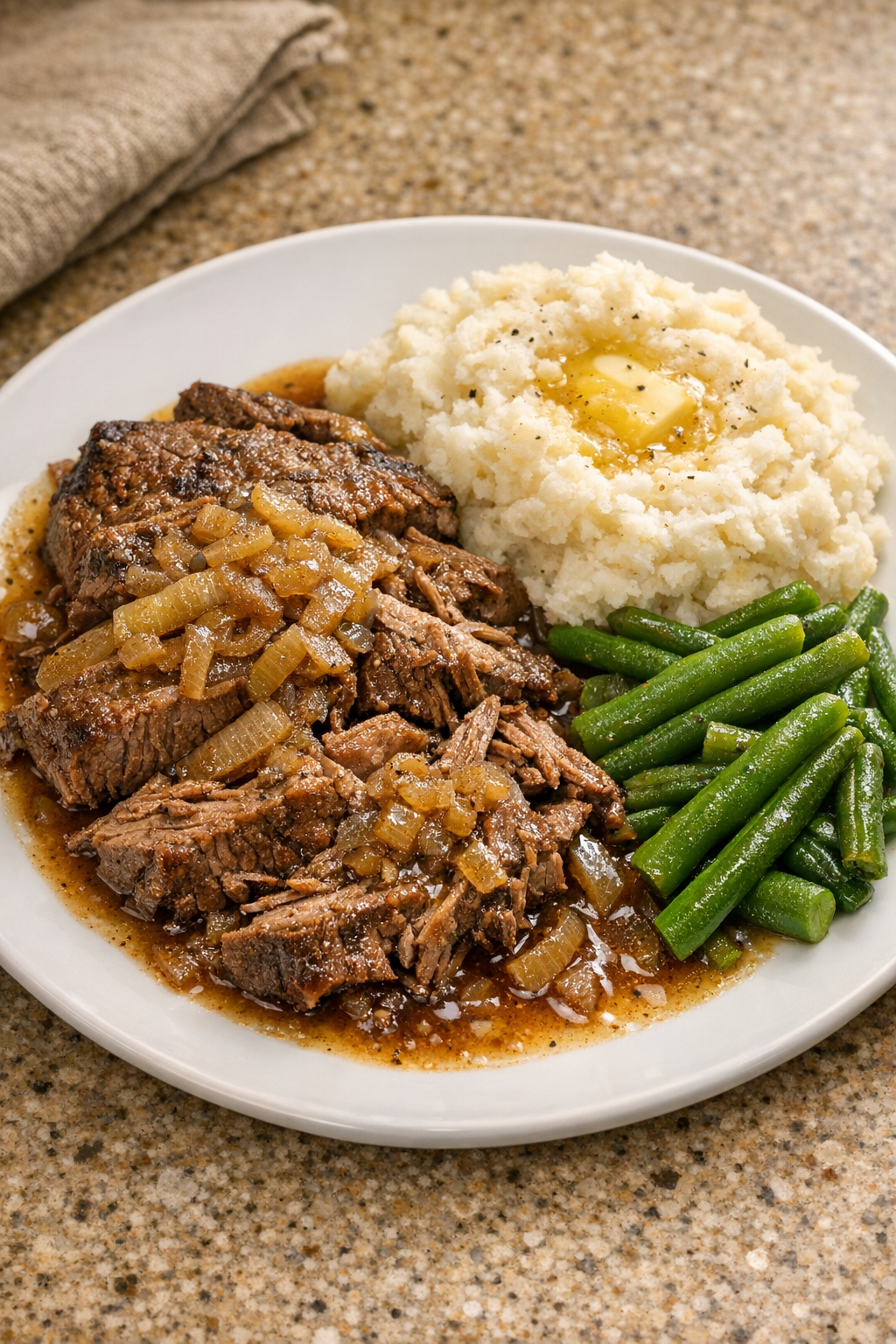 Finished Amish Worcestershire beef plated with cooking juices