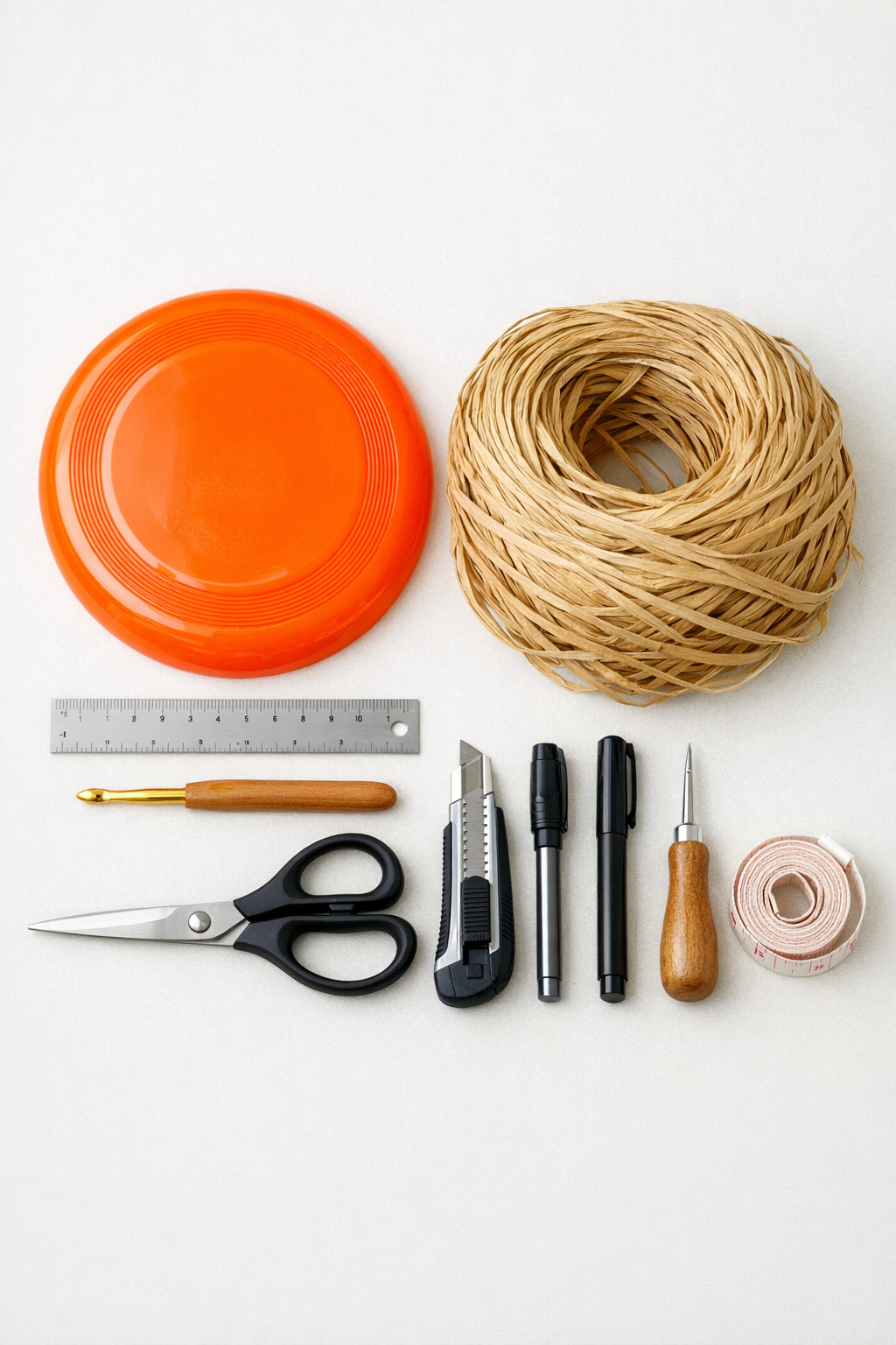Materials for making a crochet raffia sun hat with a plastic frisbee