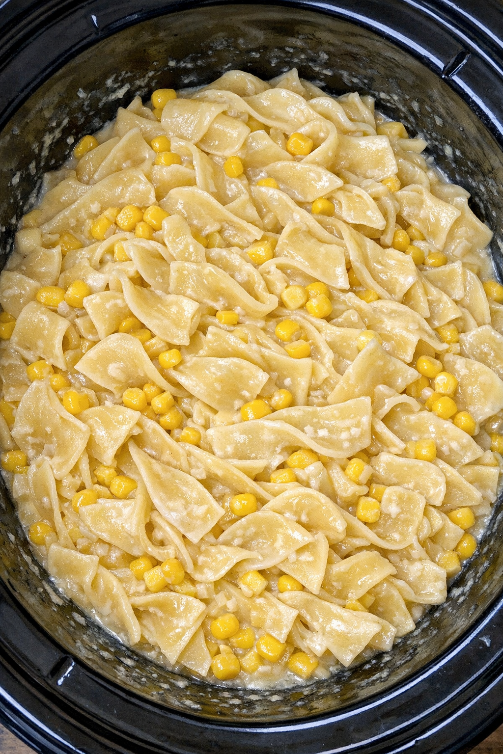 Slow cooker Amish corn noodles in a black slow cooker