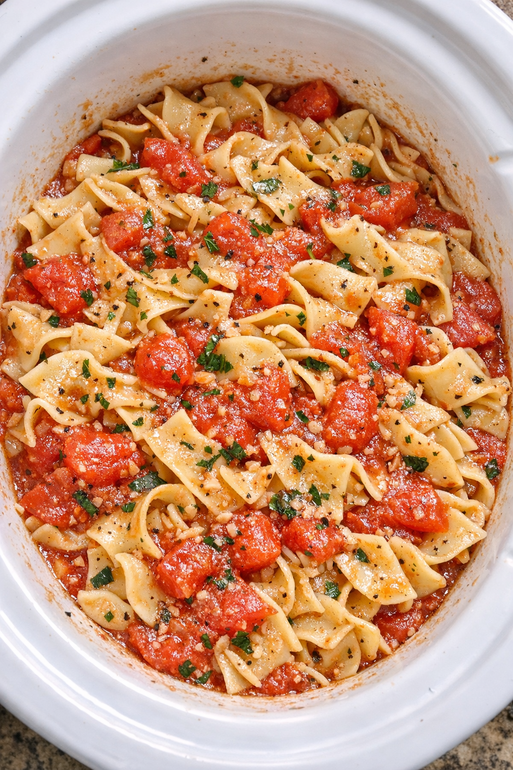 Slow cooker Amish fresh tomato noodles in a white slow cooker