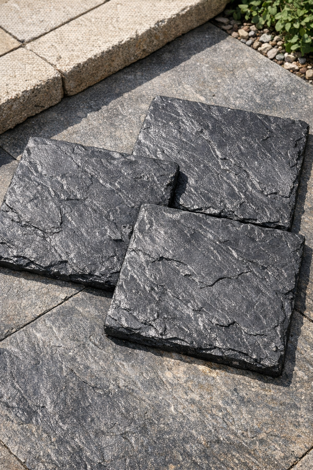 Finished faux slate patio tiles made from black plastic bags