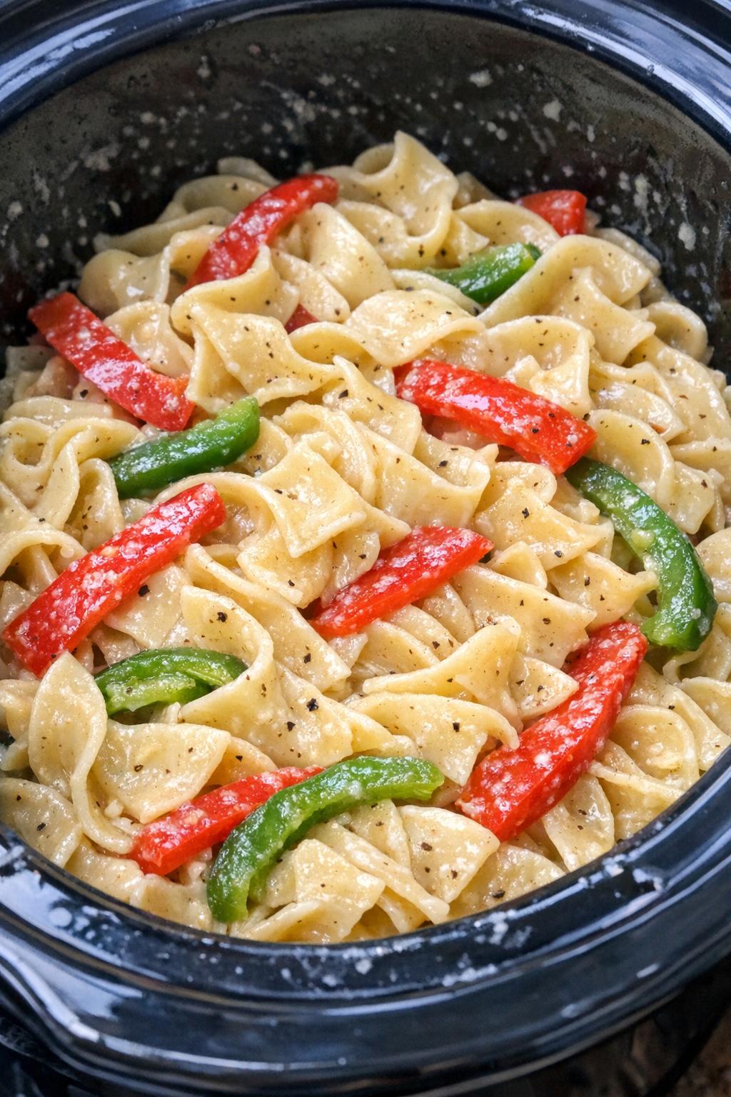 Slow cooker Amish sweet pepper noodles in a black slow cooker