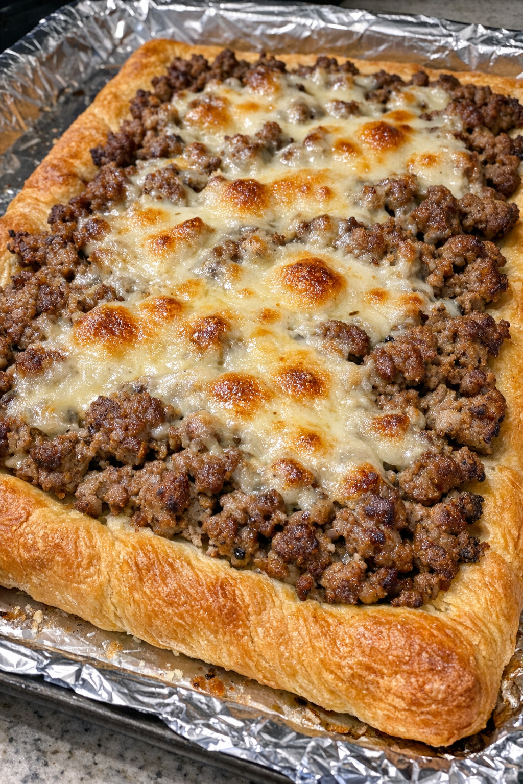 Oven baked beef crescent flatbread with melted provolone
