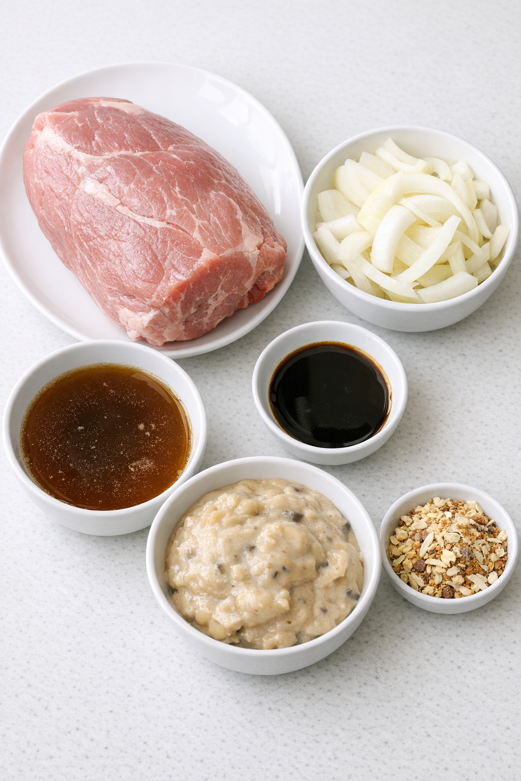 Pork roast and simple ingredients laid out on a counter