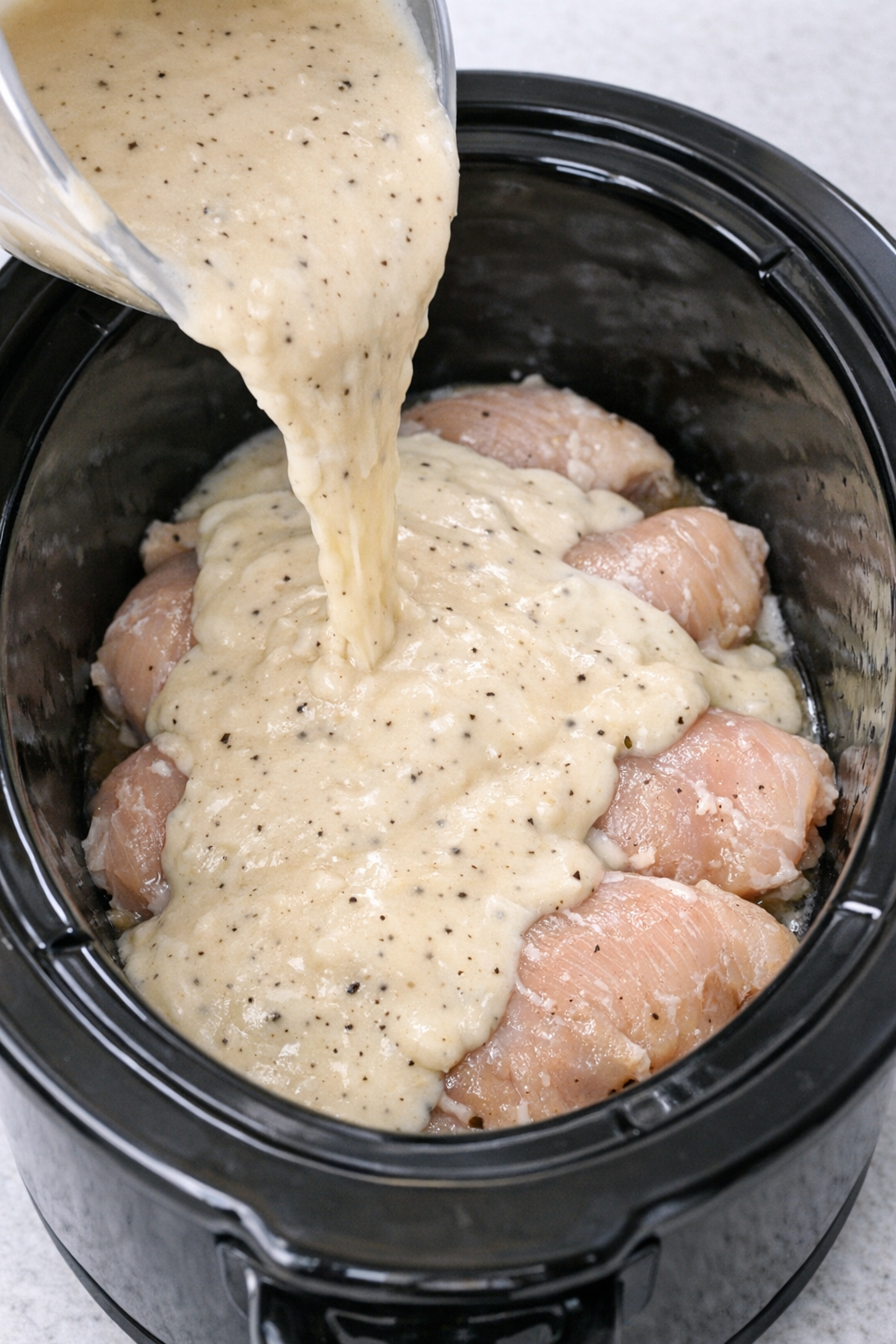 Cream soup and broth mixture poured over chicken