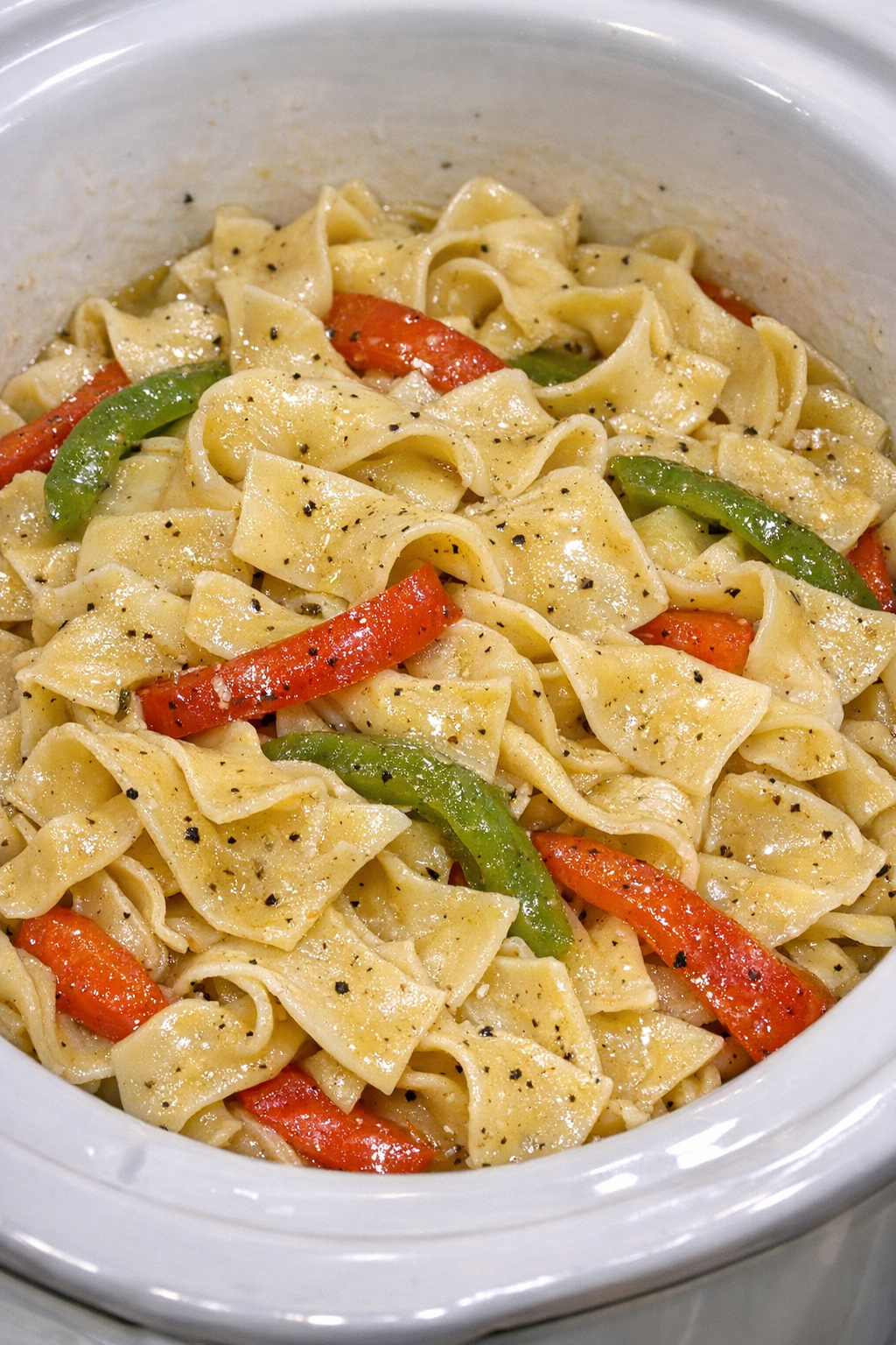 Slow cooker Amish pepper noodles in a white slow cooker