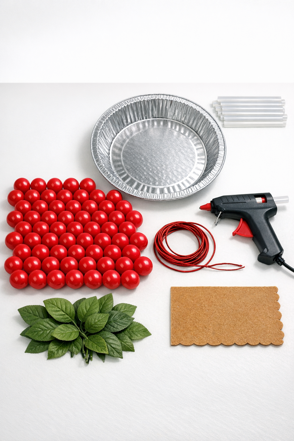 Materials for a giant cherry pie door hanger laid out neatly