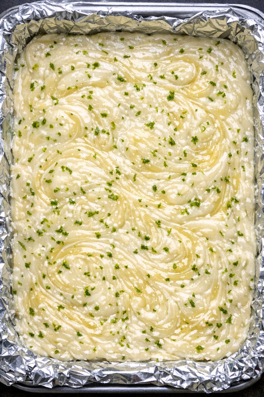 Slow cooker Brazilian lemonade fudge in a foil-lined baking sheet