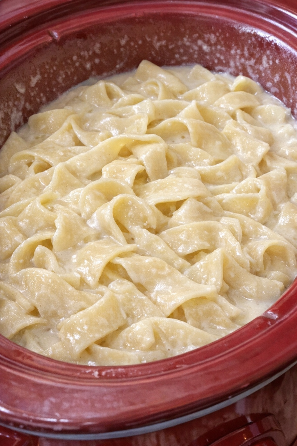 Creamy Amish milk noodles in a red slow cooker