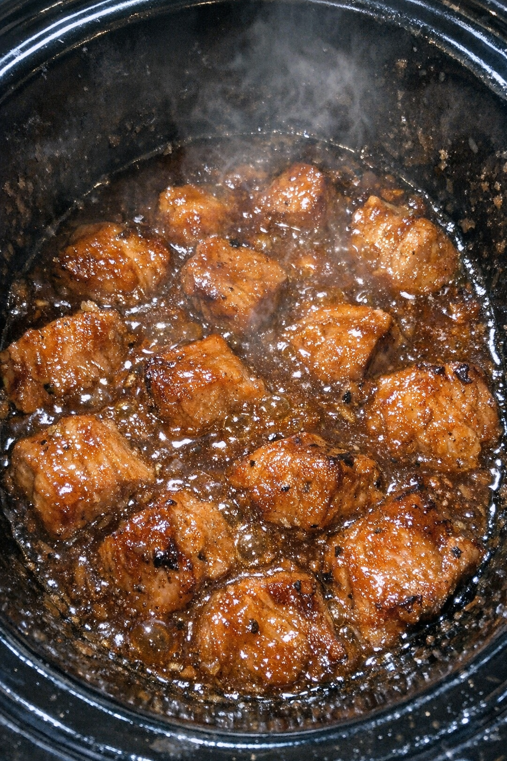 Slow cooker pork cubed steaks in bubbling amber glaze