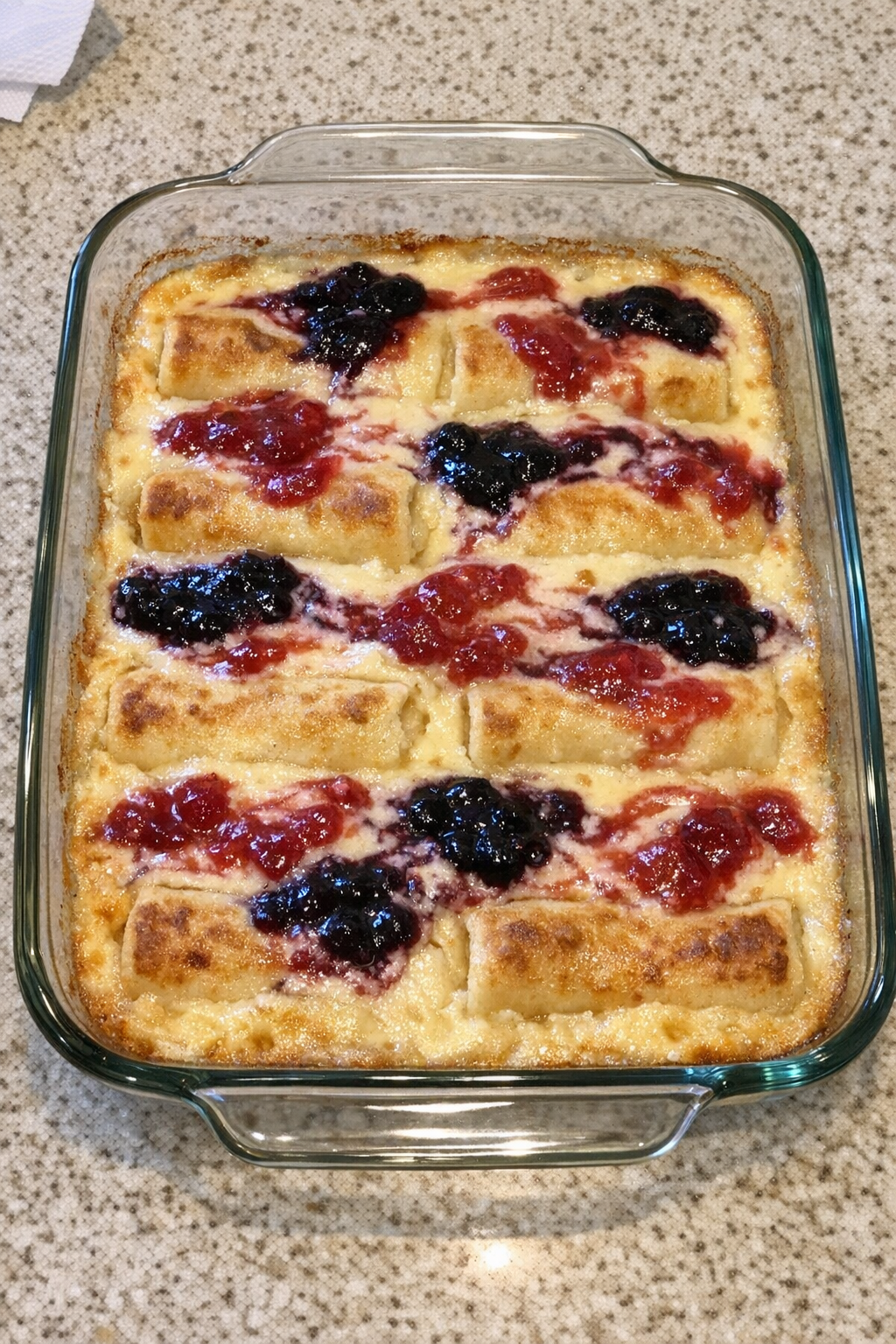 Finished baked cheese blintz dessert in a glass baking dish