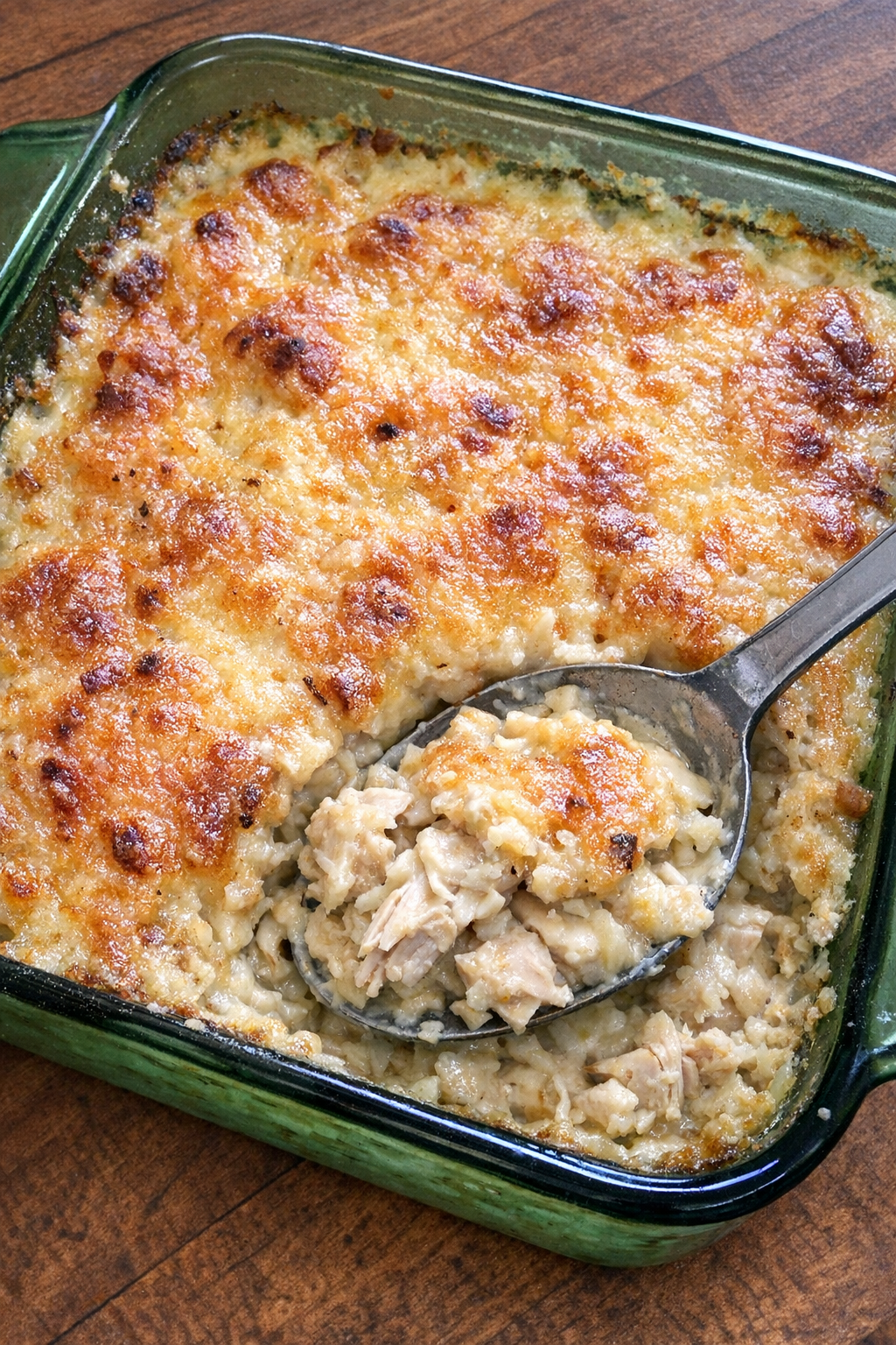 Creamy chicken casserole in a vintage green baking dish
