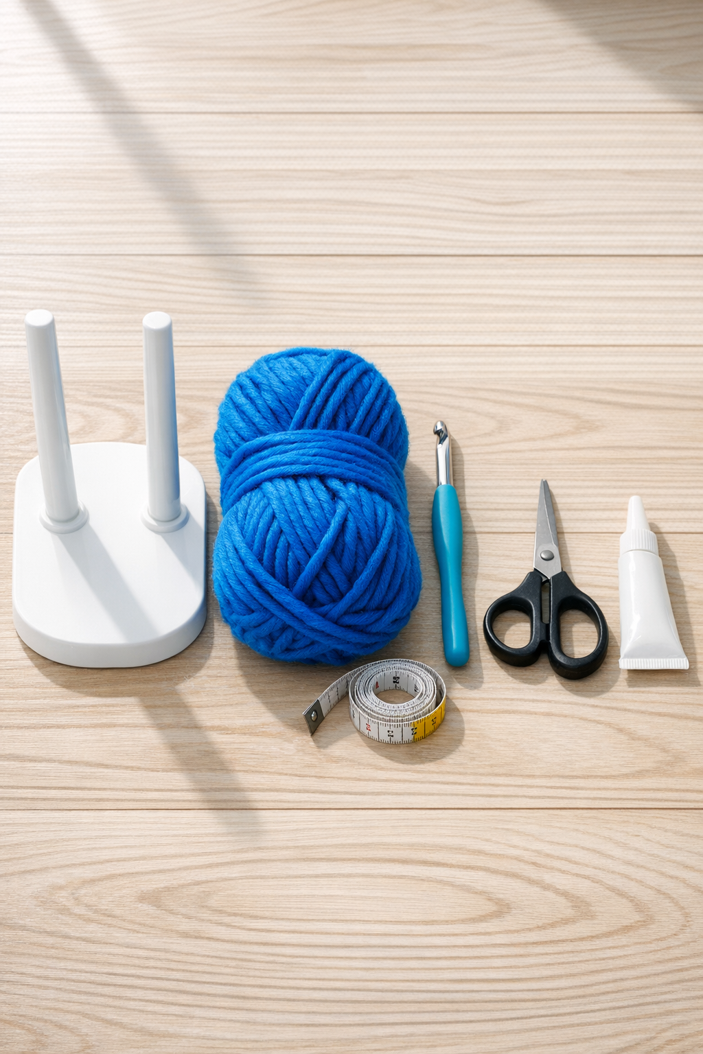 Materials for a crocheted headphone organizer laid out on a table