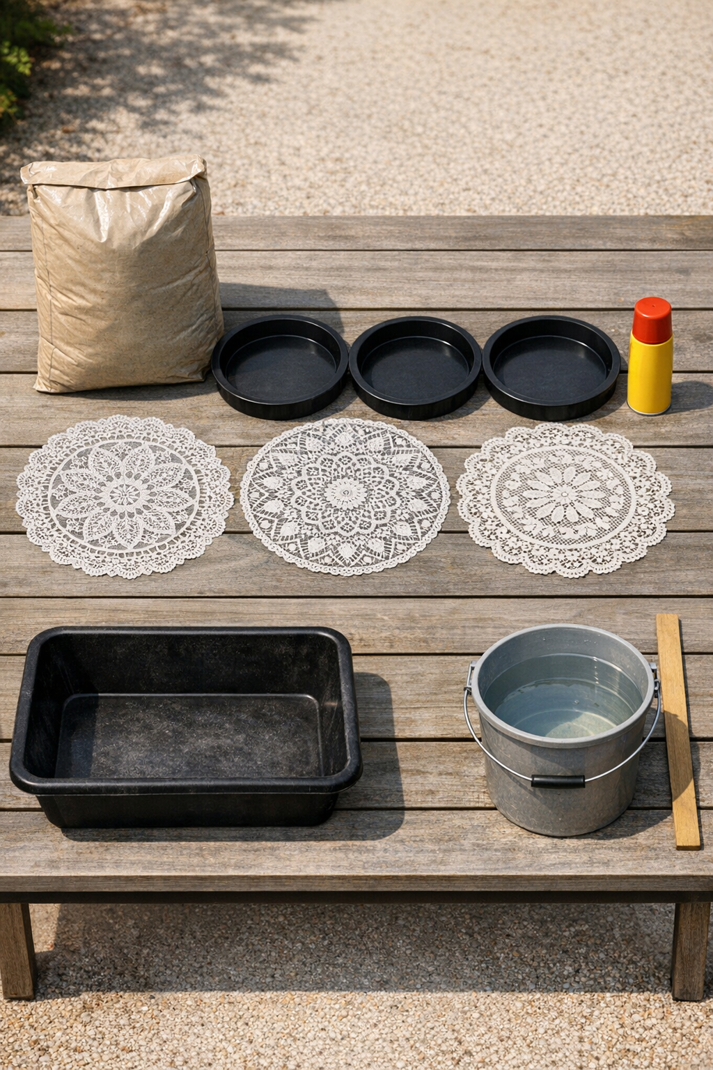 Materials for making patterned patio stones laid out on a work surface