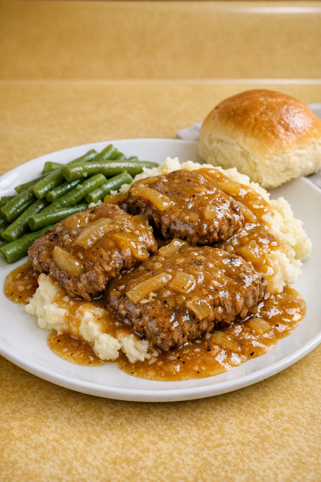Finished slow cooker cube steaks with gravy on a plate