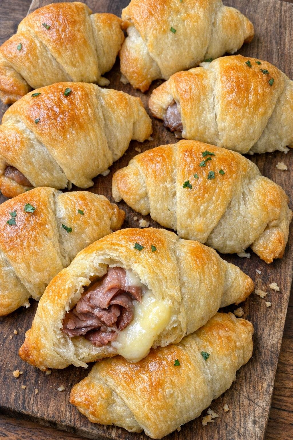 Puffy golden crescent pillows with roast beef and butterkase