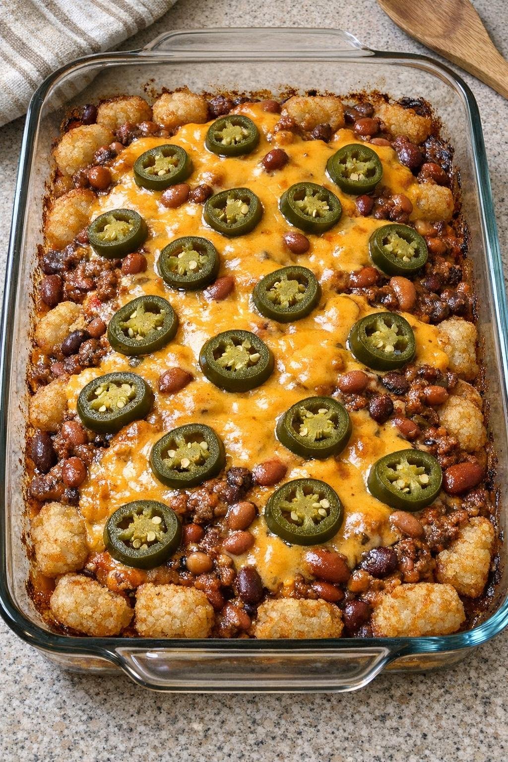 Finished baked totchos casserole in a glass dish