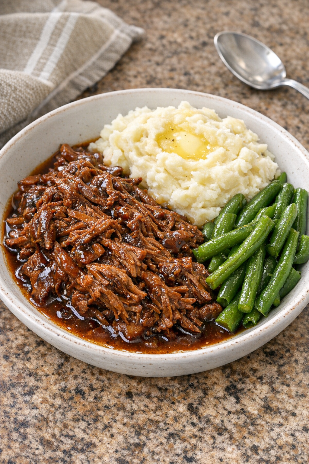 Plated slow cooker cola beef with glossy sauce