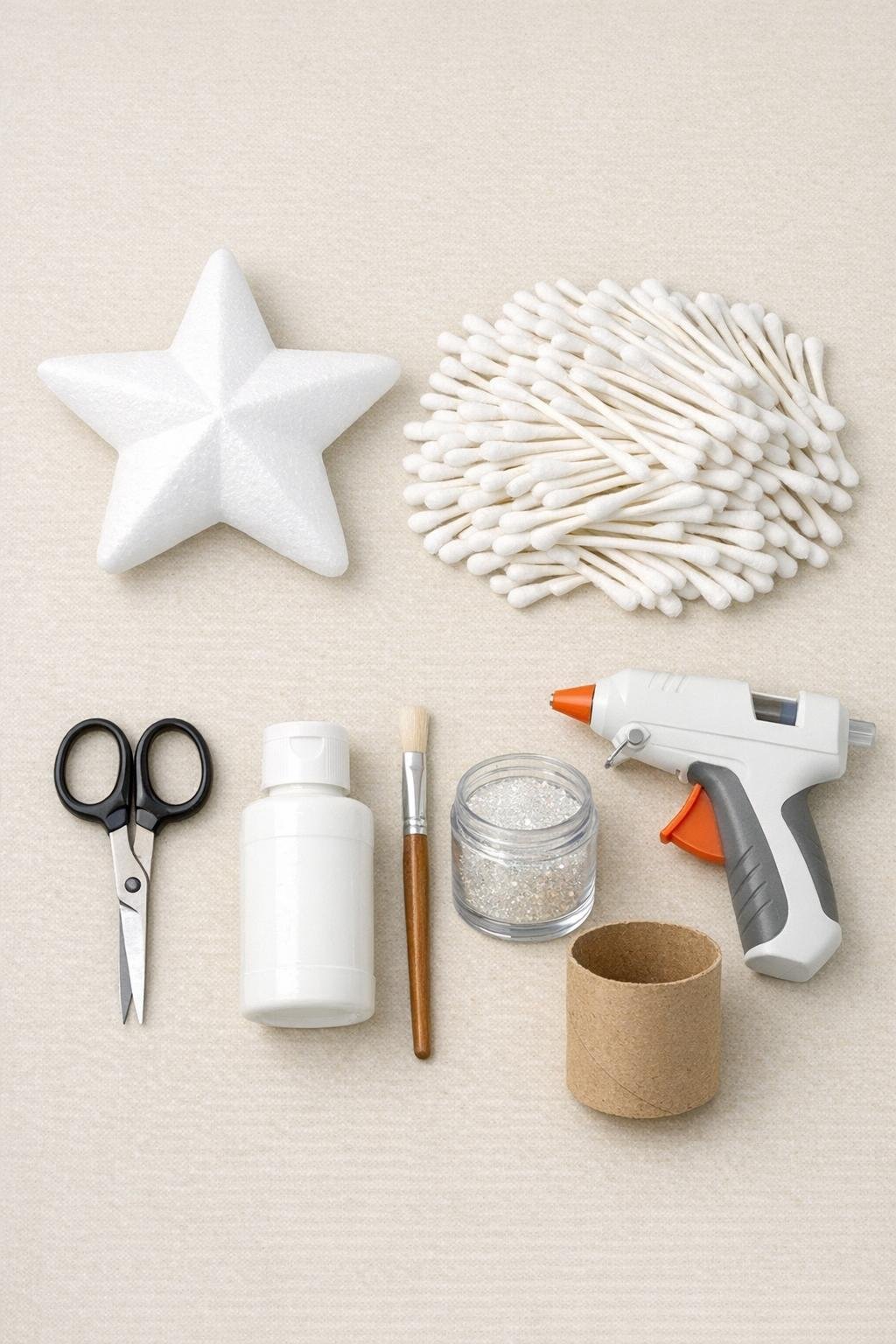Materials for a cotton swab foam star tree topper laid out on a craft table