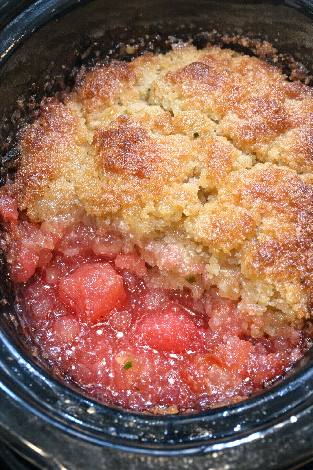 Slow cooker watermelon margarita cobbler in a black slow cooker
