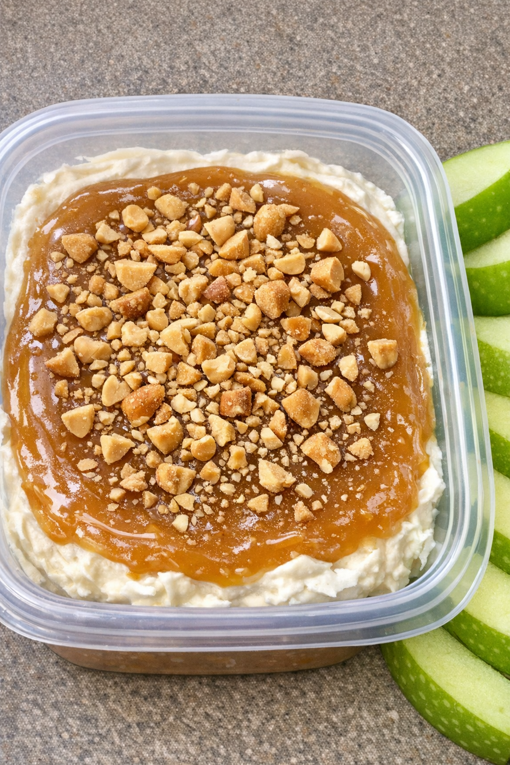 Caramel apple dip in a container with apple slices