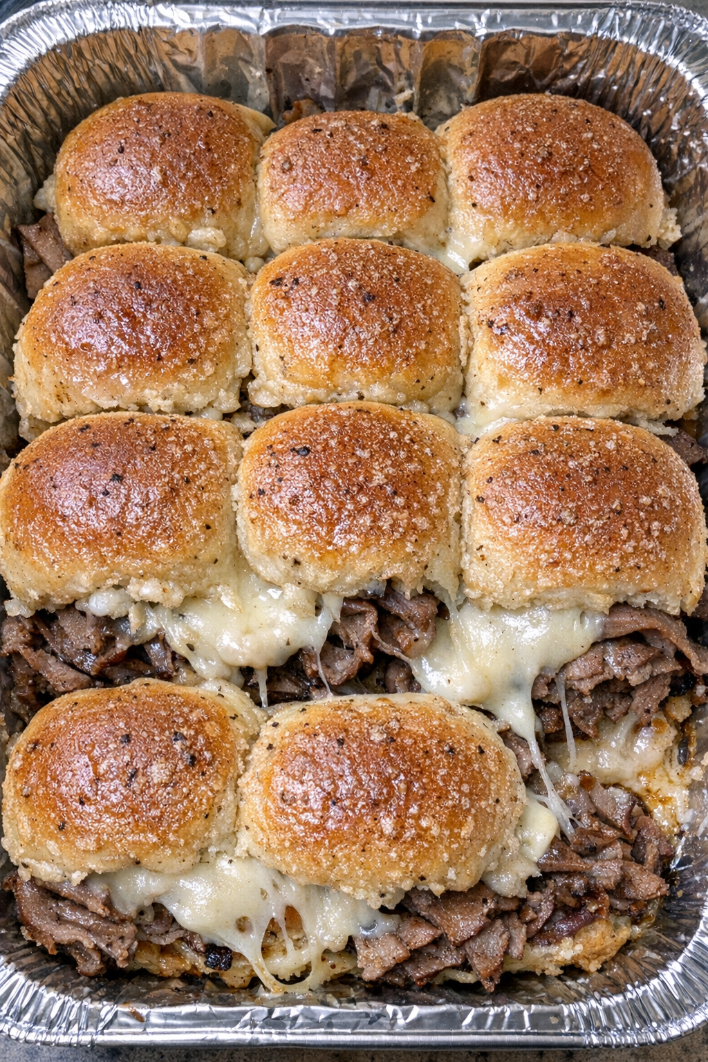 Oven baked beef slider bites in a foil tray