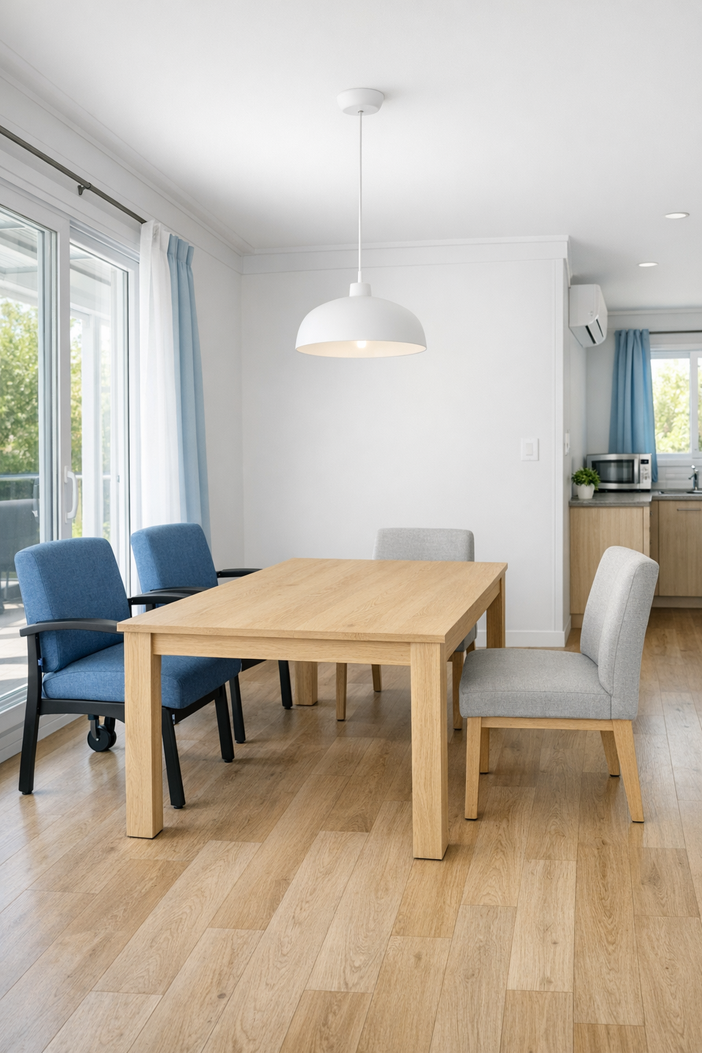 Accessible dining area with pale wood table and warm pendant light