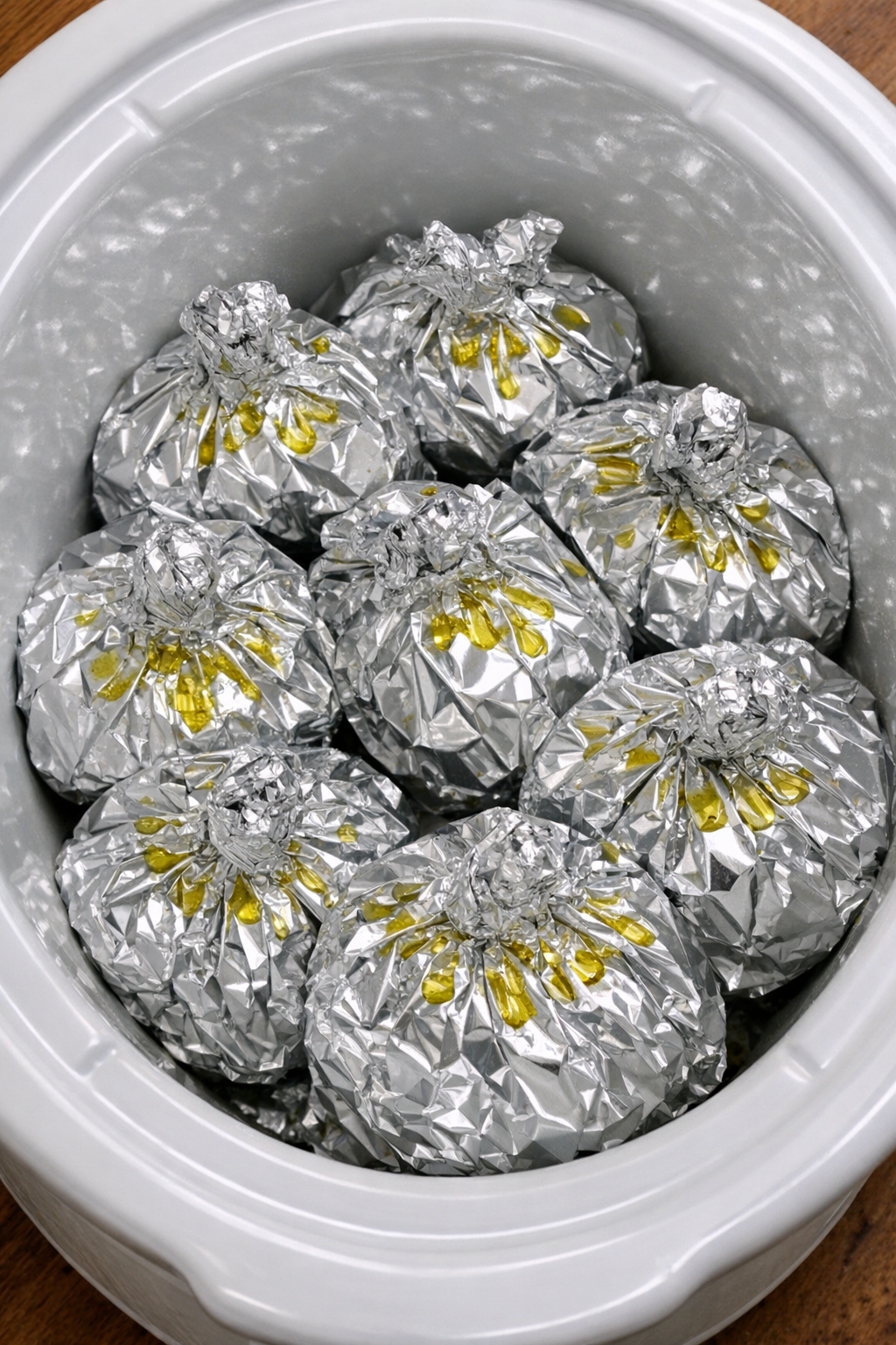 Greek chicken pasta packets in foil in a slow cooker