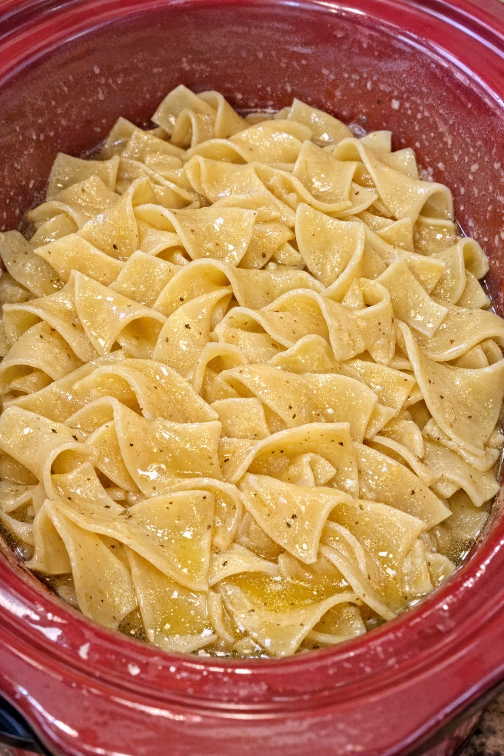 Slow cooker Amish cider vinegar noodles in a red slow cooker