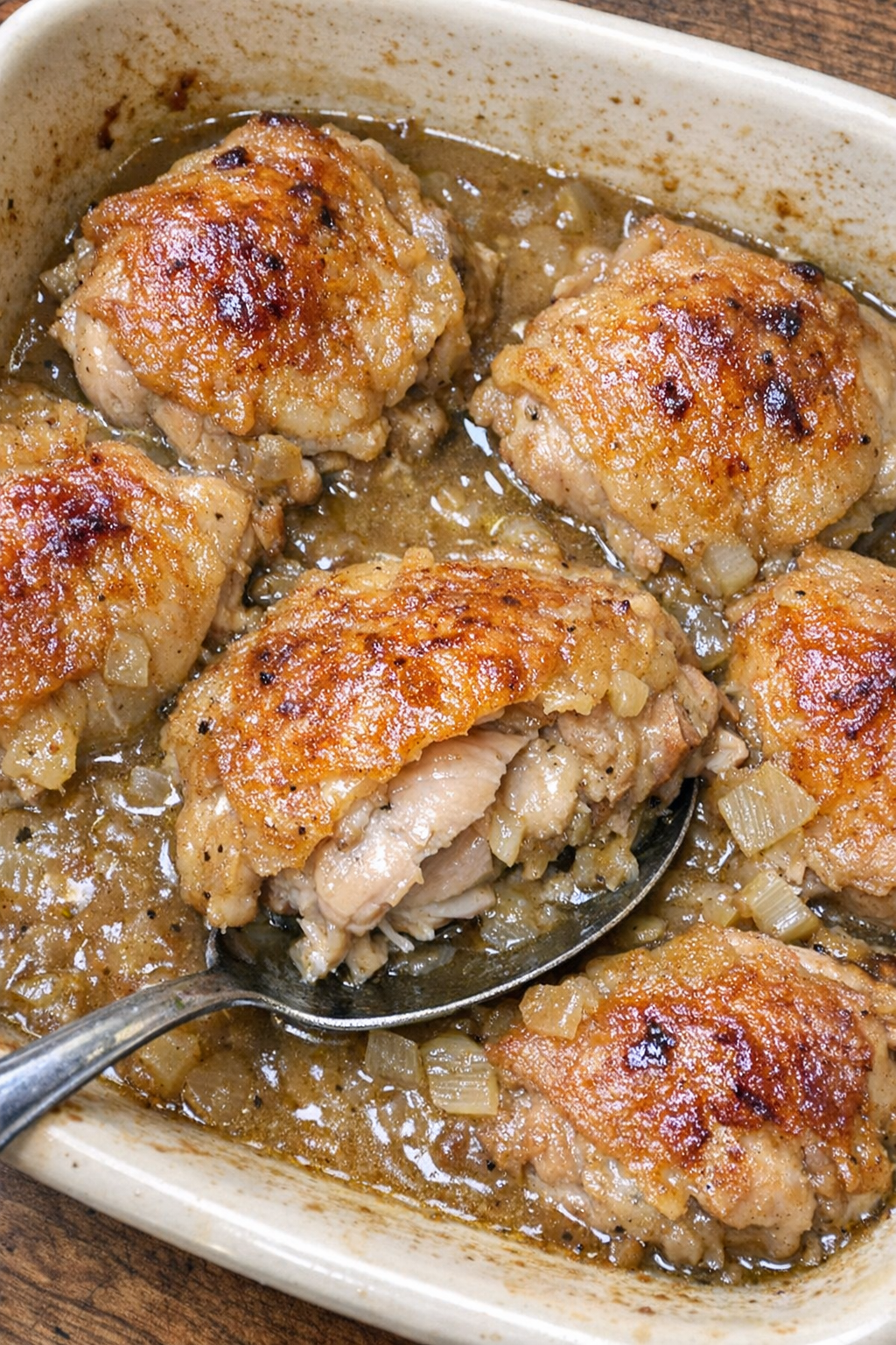 Baked chicken in gravy in a stoneware dish