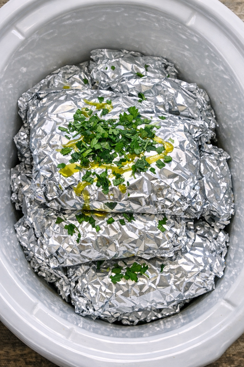 Creamy green goddess pasta packets stacked in a white slow cooker