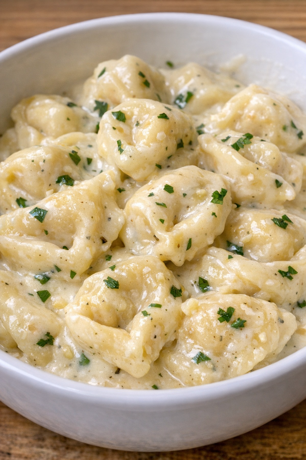 Creamy garlic butter tortellini in a white bowl