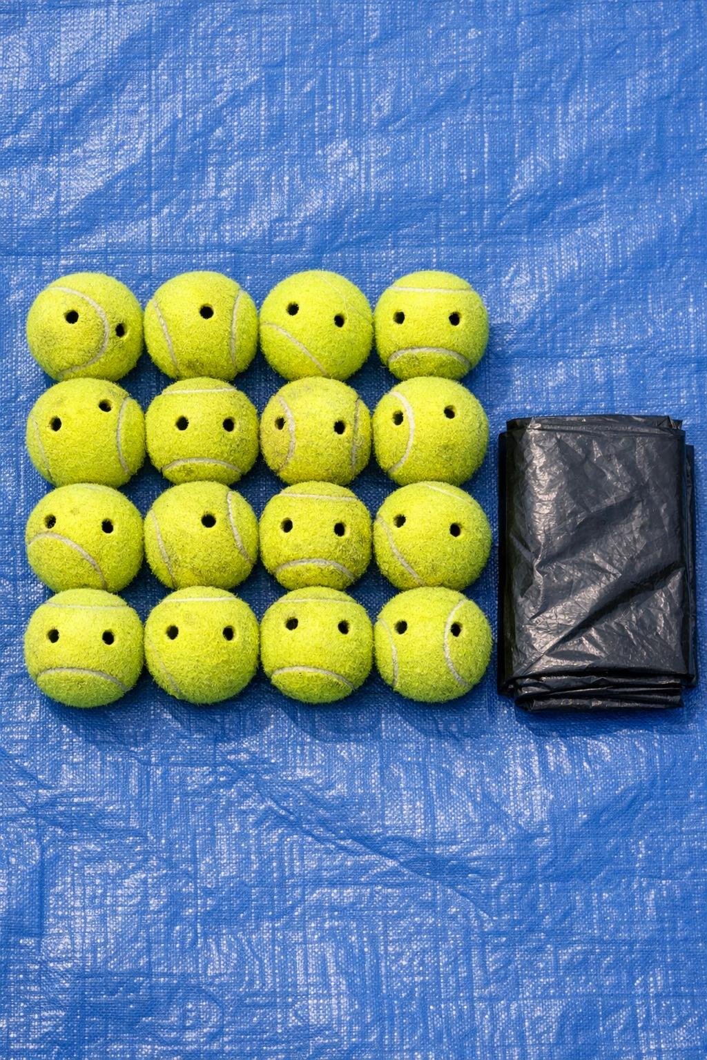 Old tennis balls and a black trash bag laid out for the project