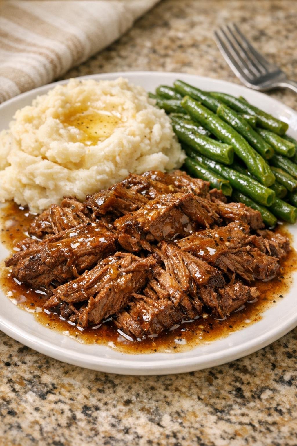 Plated shredded harvest beef with rich buttery sauce